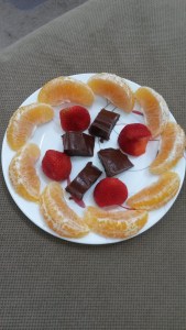 Chocolate peanut butter fudge, strawberries, and orange slices